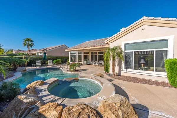 a house view with a swimming pool and outdoor space