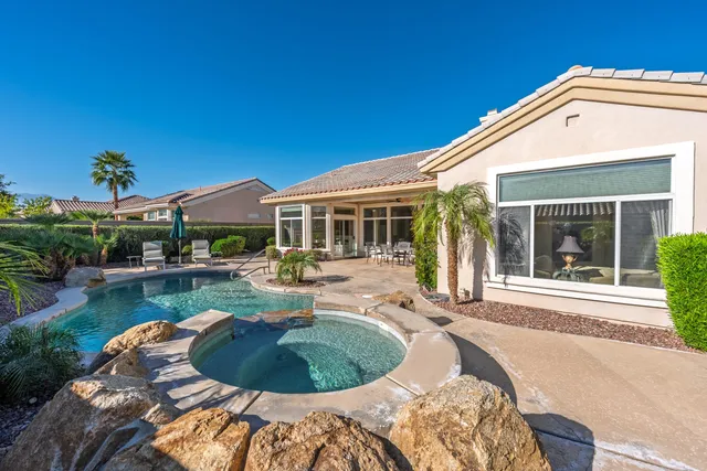 a house view with a swimming pool and outdoor space