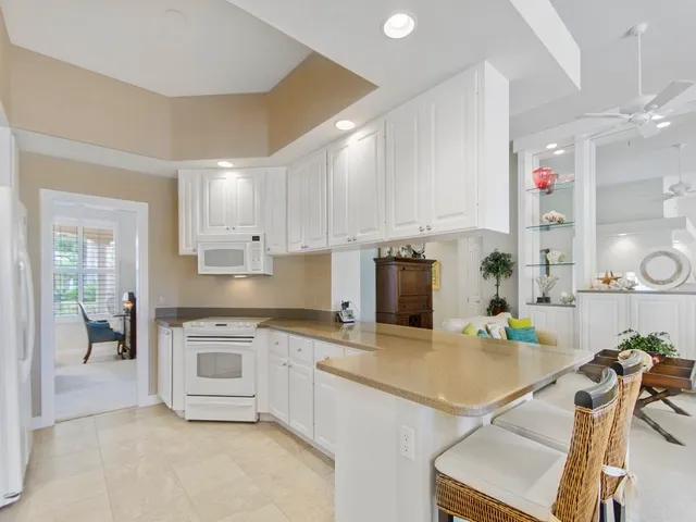 a kitchen with a sink a stove and cabinets