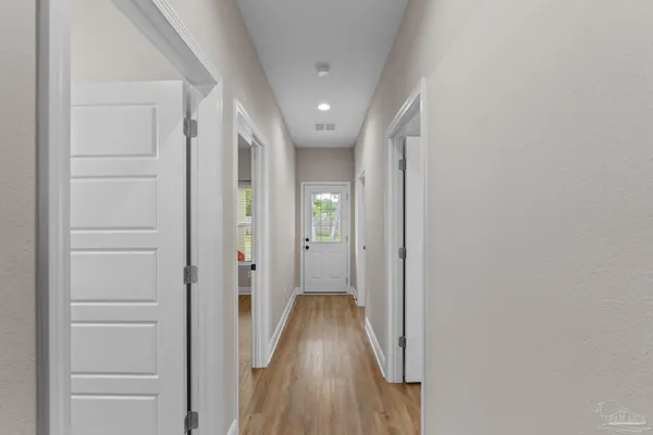 a view of hallway with wooden floor