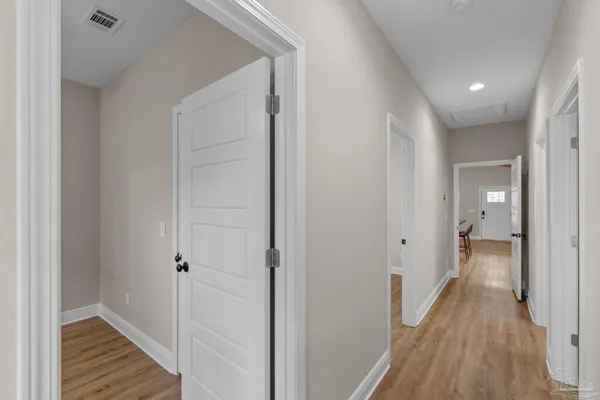 a view of a hallway with wooden floor