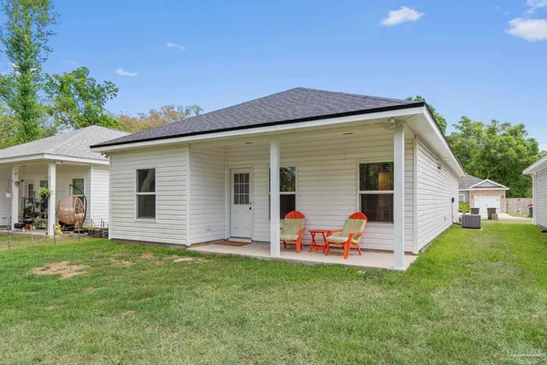 a front view of house with yard and outdoor seating