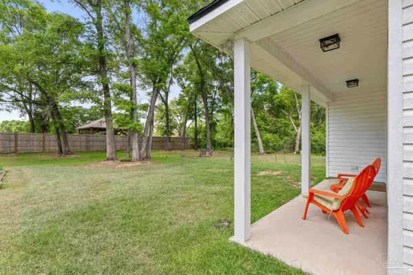 a backyard of a house with outdoor seating