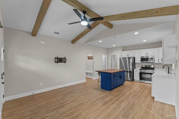 a view of kitchen with furniture and wooden floor
