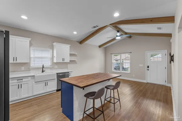 a open kitchen with a table and chairs in it