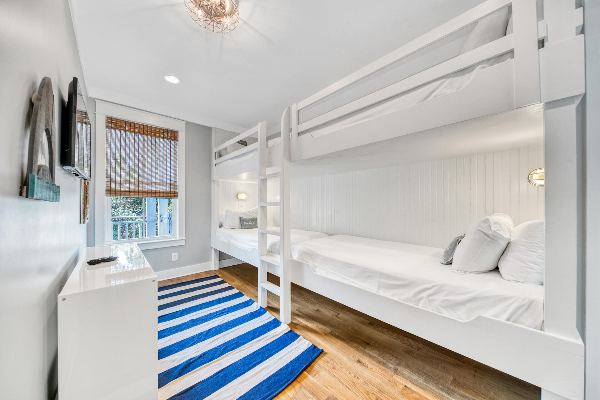 21 Beachcomber Ln Inlet Beach Inlet Beach, FL 32461 - Photo 28 of 60 a bedroom with a bed and a chandelier