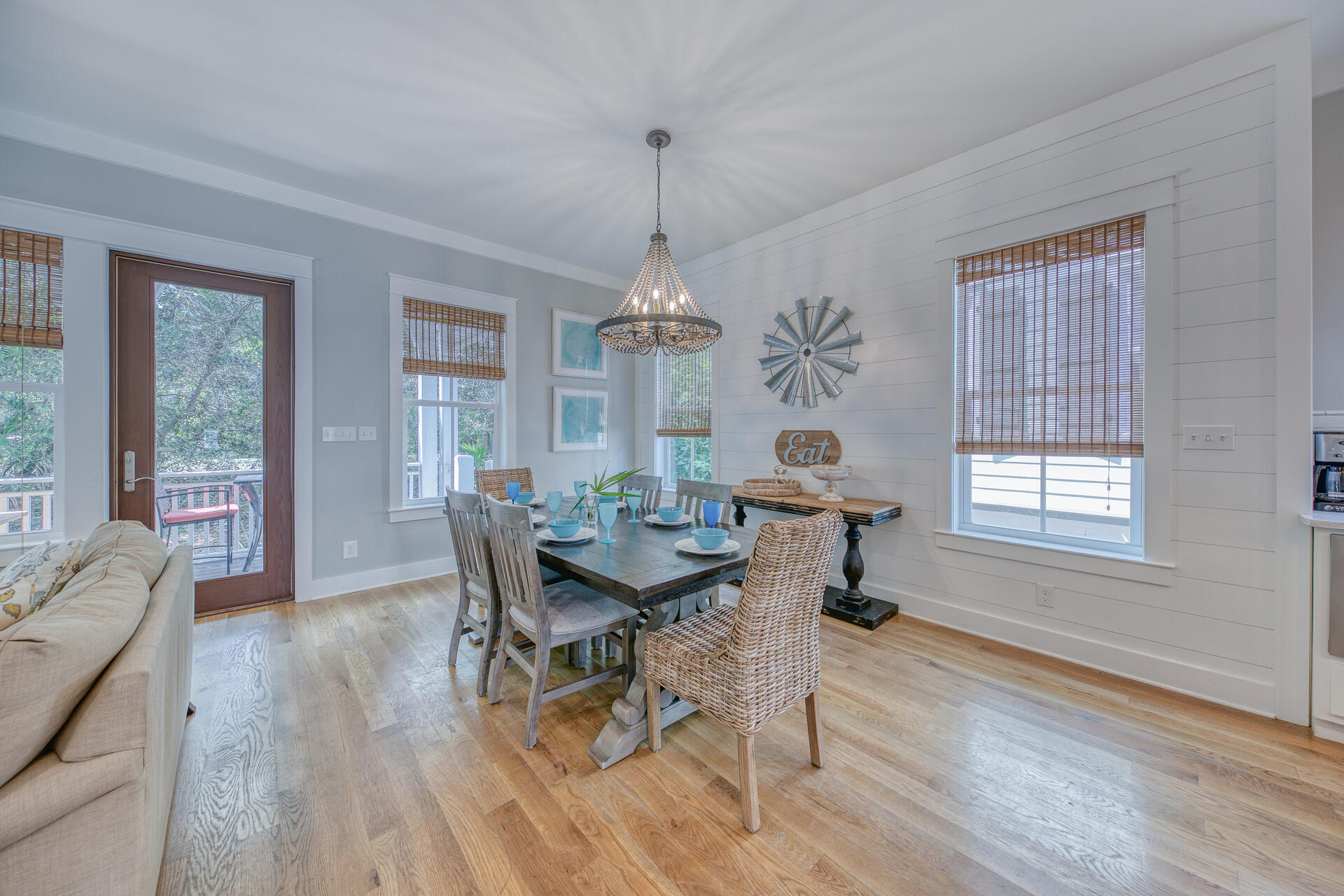 21 Beachcomber Ln Inlet Beach Inlet Beach, FL 32461 - Photo 7 of 60 a dining room with wooden floor a chandelier a wooden table and chairs