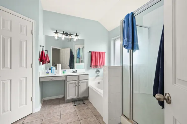 a bathroom with a sink vanity and mirror
