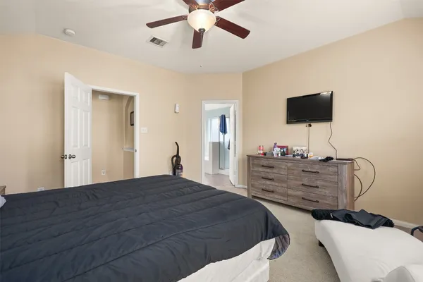 a bed room with a bed and a television