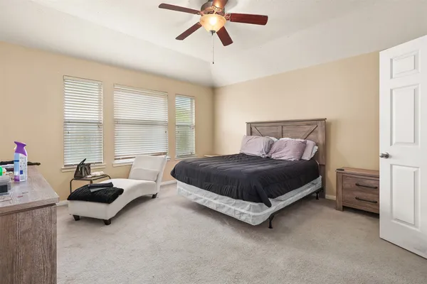 a spacious bedroom with a bed and window