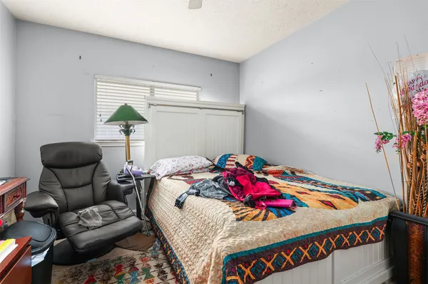 a bedroom with a bed and a table in it