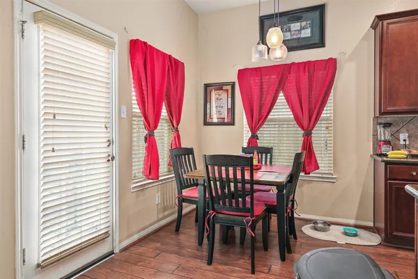 a view of a dining room with furniture and a window