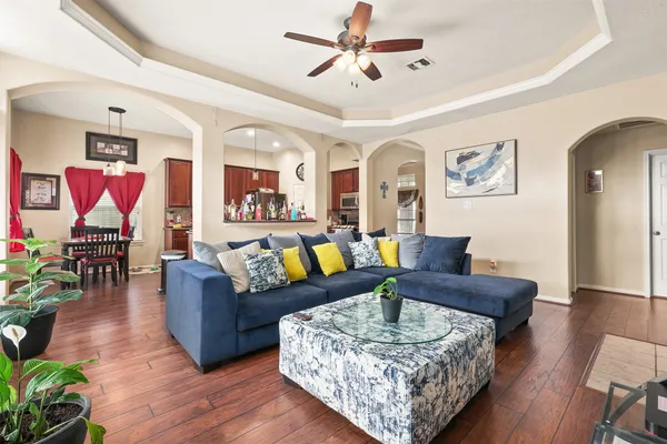 a living room with furniture and wooden floor