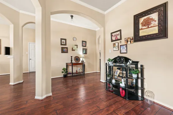a view of a hallway with wooden floor and a workspace