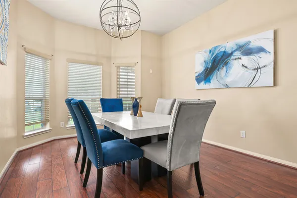 a view of a dining room with furniture wooden floor and chandelier