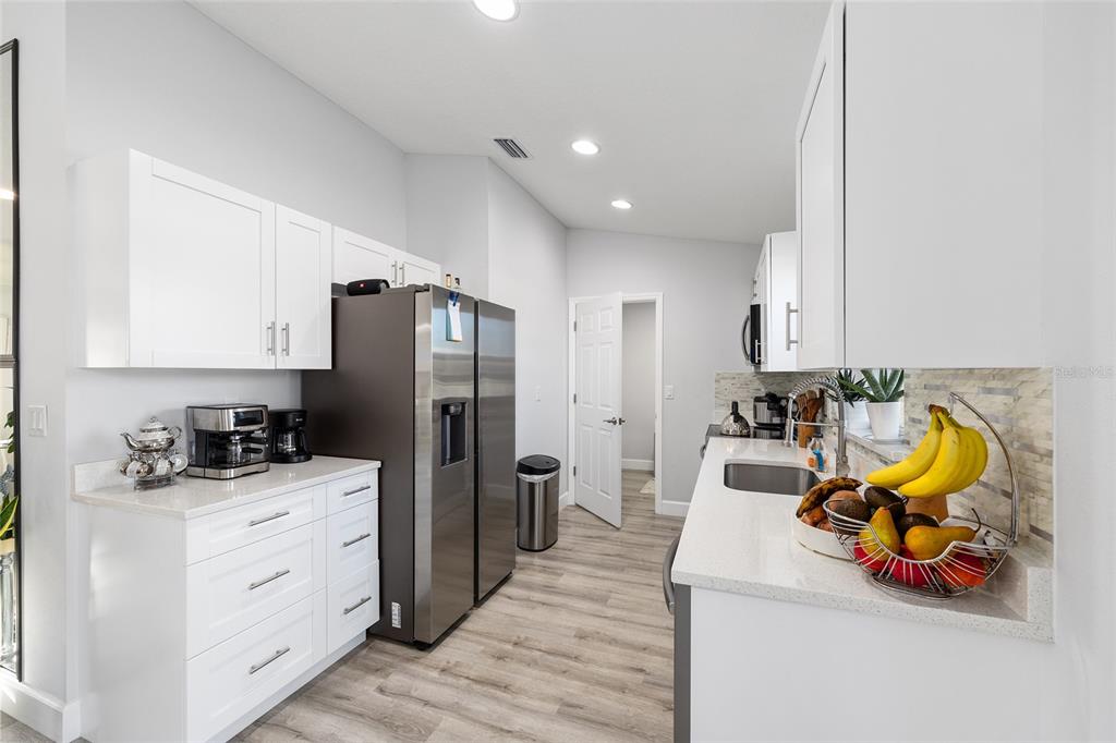 3597 Southwest 151st Avenue Ocala, FL 34481 - Photo 12 of 35 a kitchen with stainless steel appliances a sink a stove and refrigerator