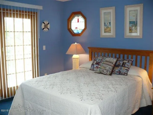 a large bed sitting in a bedroom next to a window