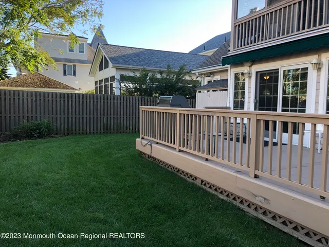 a view of a house with a yard and deck