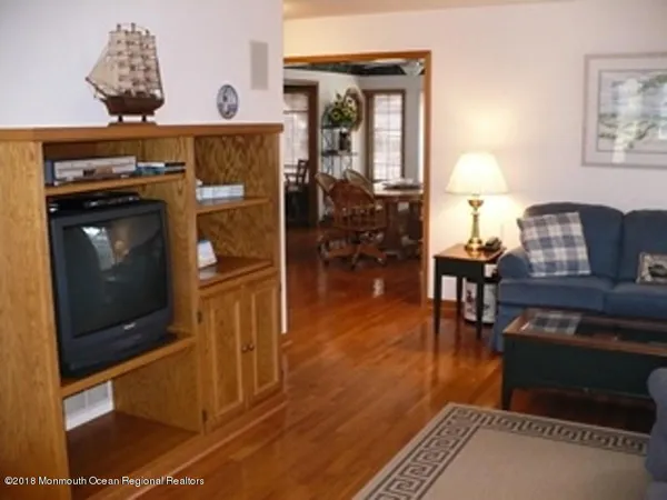 a living room with furniture a dining table and a fireplace