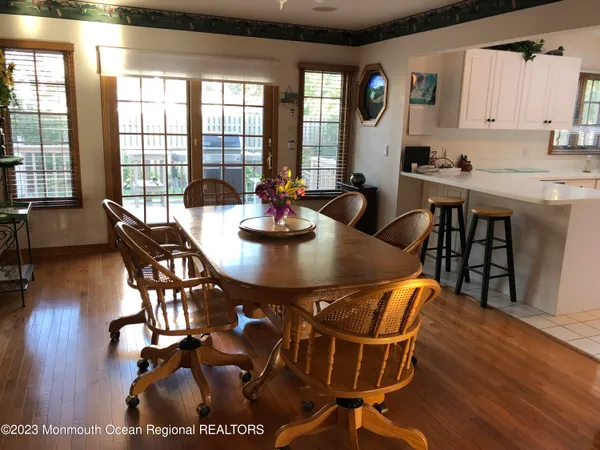 a view of a dining room with furniture window and wooden floor
