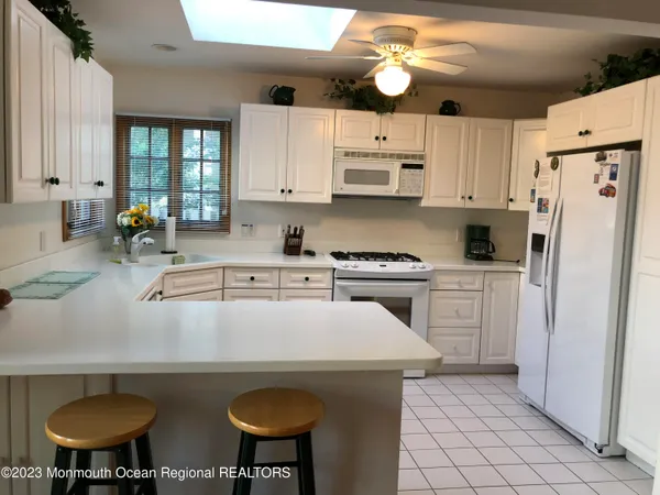a kitchen with stainless steel appliances a white cabinets and stove top oven