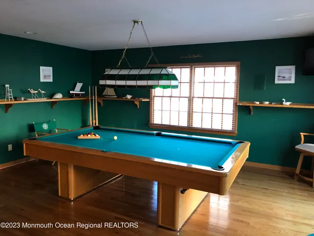 a room with pool tables and windows