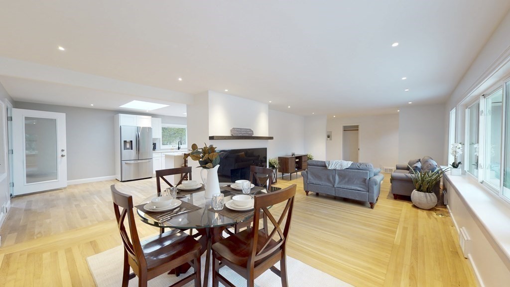 4 Sunset Drive Walpole, MA 02081 - Photo 16 of 37 a dining room with furniture a fireplace and kitchen view