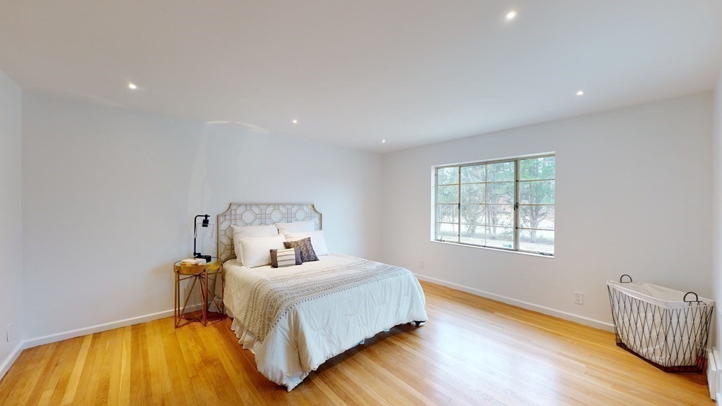 4 Sunset Drive Walpole, MA 02081 - Photo 20 of 37 a bedroom with a bed and wooden floor