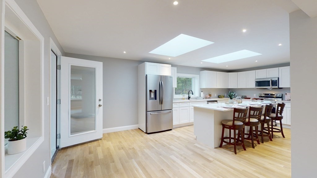 4 Sunset Drive Walpole, MA 02081 - Photo 2 of 37 a kitchen with stainless steel appliances granite countertop a refrigerator and a stove top oven