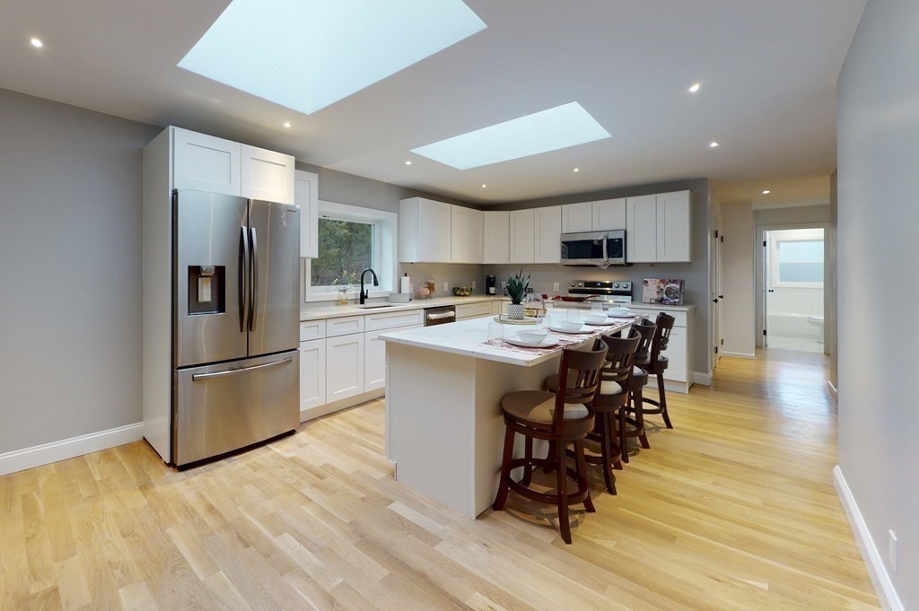 4 Sunset Drive Walpole, MA 02081 - Photo 3 of 37 a kitchen with stainless steel appliances a stove a sink a refrigerator and a microwave