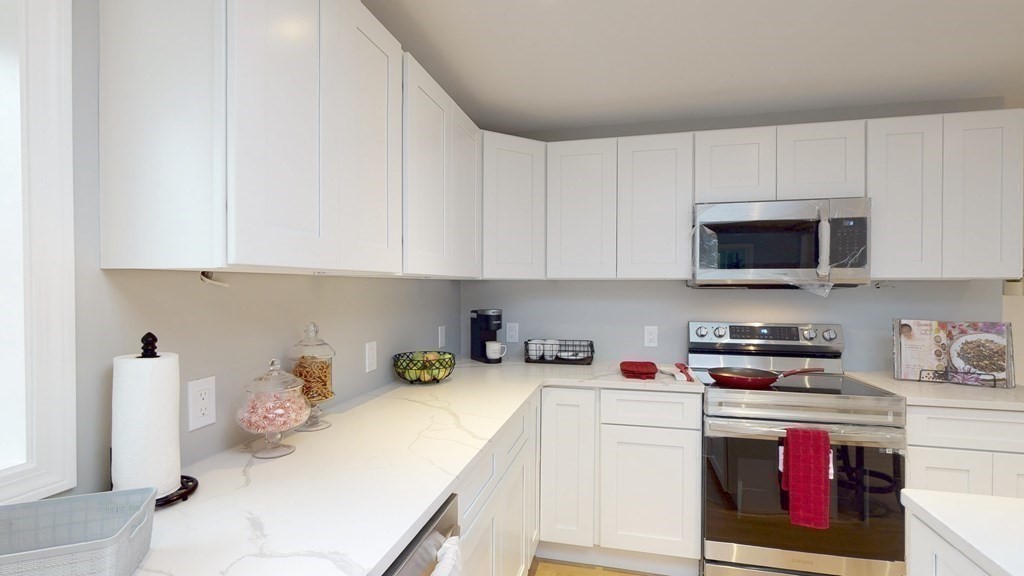 4 Sunset Drive Walpole, MA 02081 - Photo 4 of 37 a kitchen with stainless steel appliances granite countertop a sink and cabinets