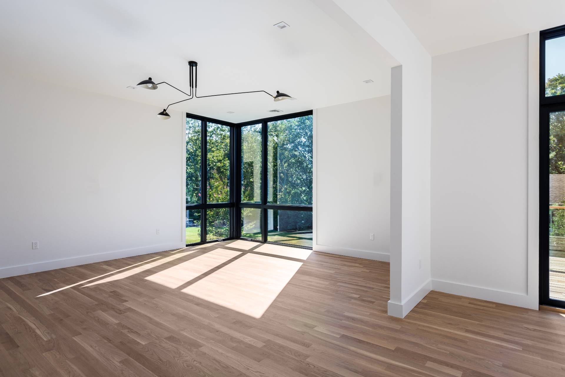 19 Peter's Path East Hampton, NY 11937 - Photo 11 of 29 an empty room with wooden floor and windows