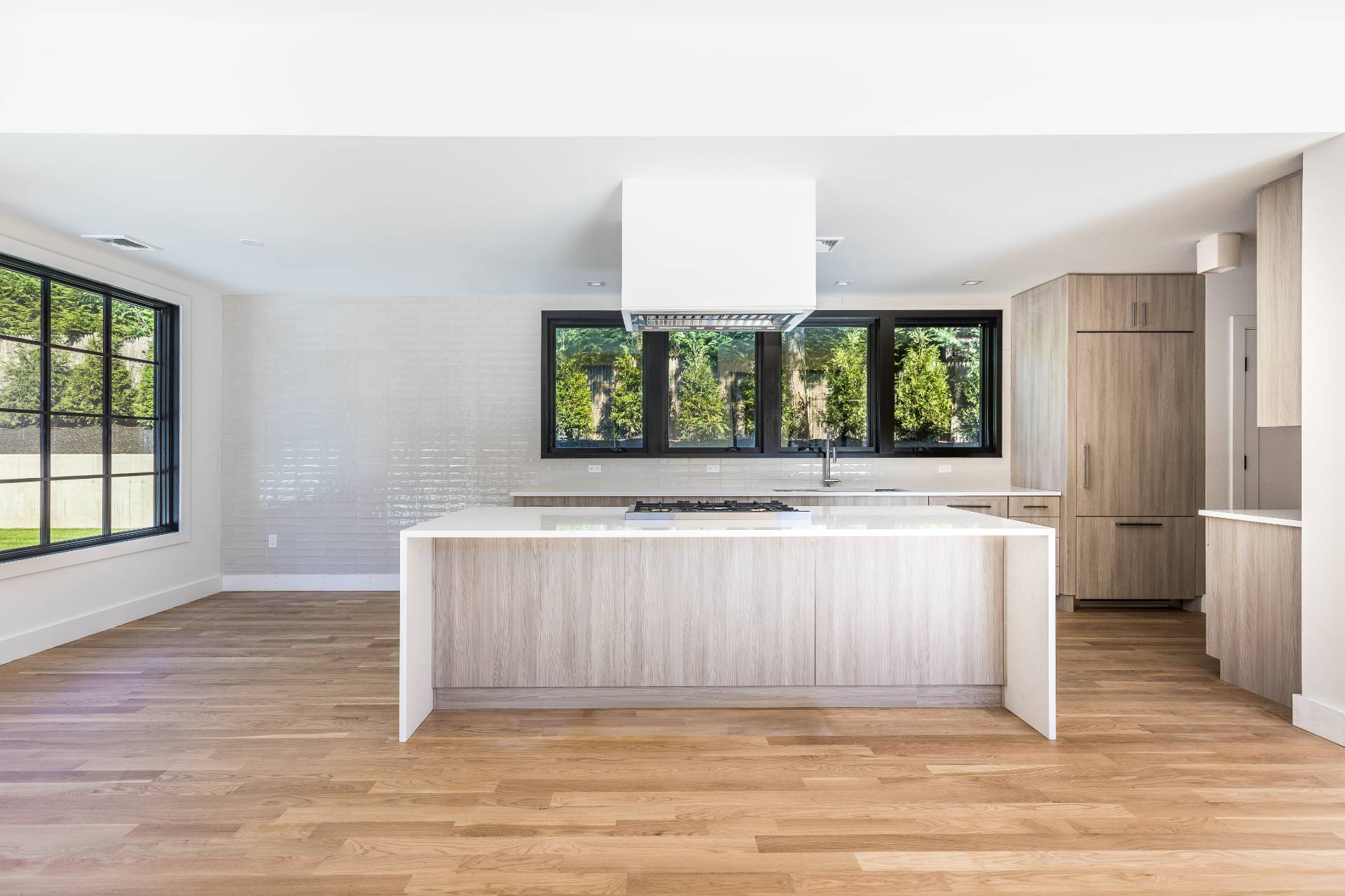 19 Peter's Path East Hampton, NY 11937 - Photo 16 of 29 a view of kitchen with stainless steel appliances wooden floor and large window