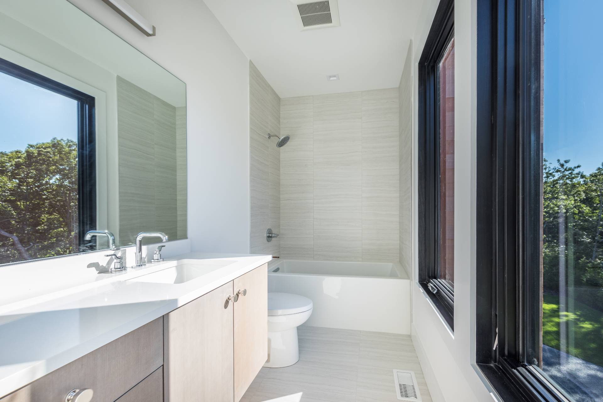 19 Peter's Path East Hampton, NY 11937 - Photo 23 of 29 a bathroom with a double vanity sink toilet and shower