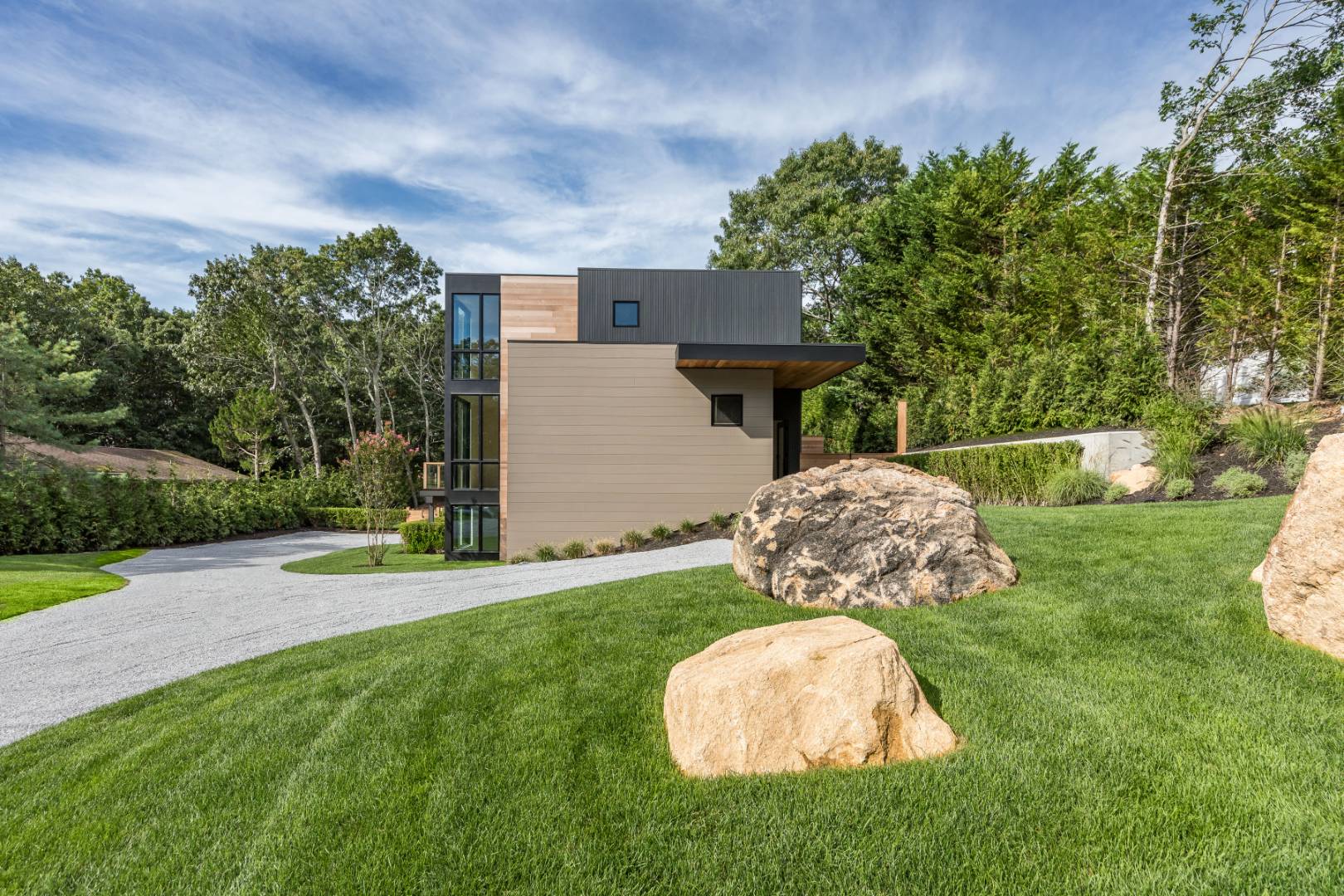 19 Peter's Path East Hampton, NY 11937 - Photo 4 of 29 a backyard of a house with table and chairs plants and large tree