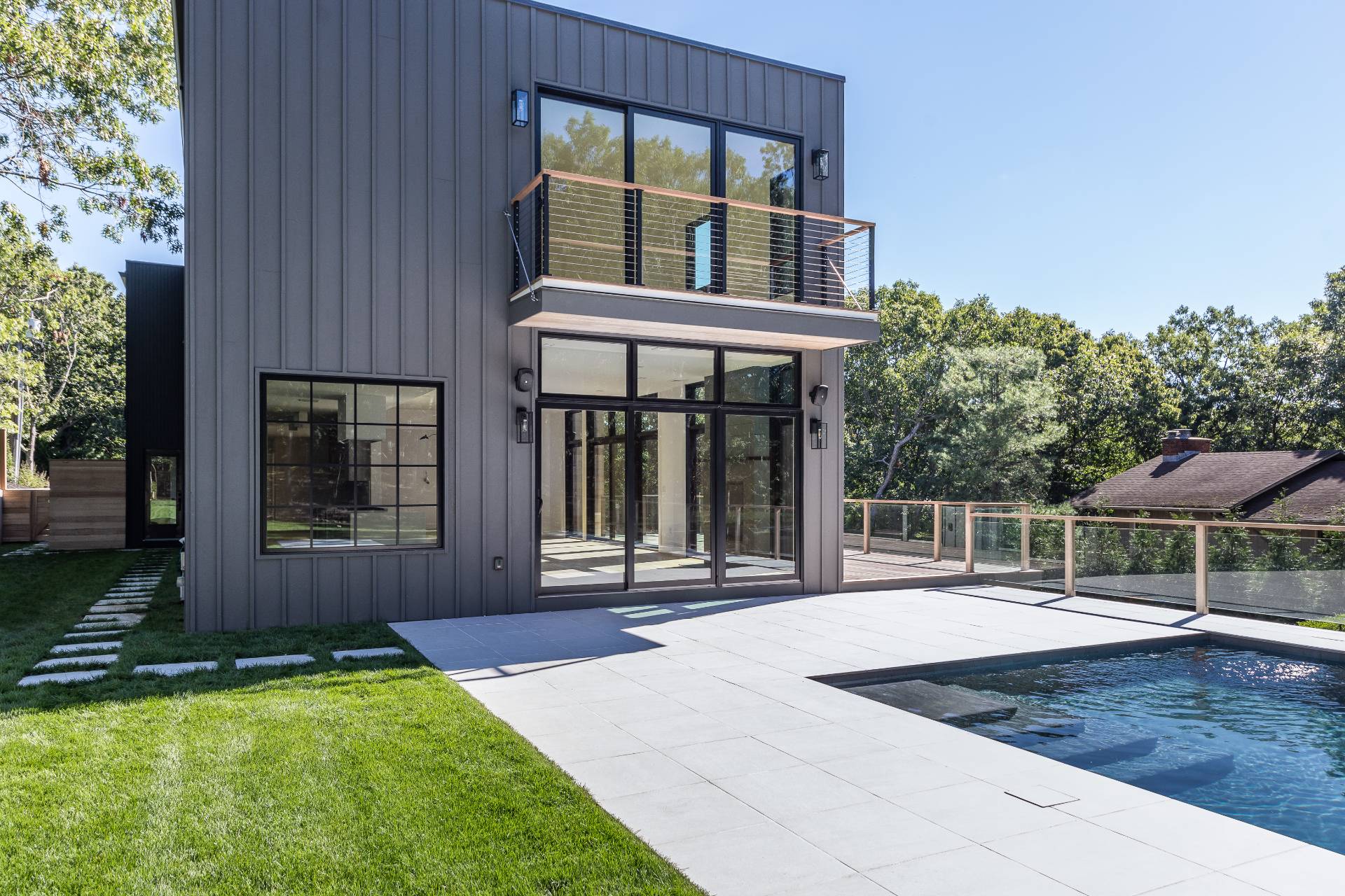 19 Peter's Path East Hampton, NY 11937 - Photo 6 of 29 a porch with a table and chairs next to a yard