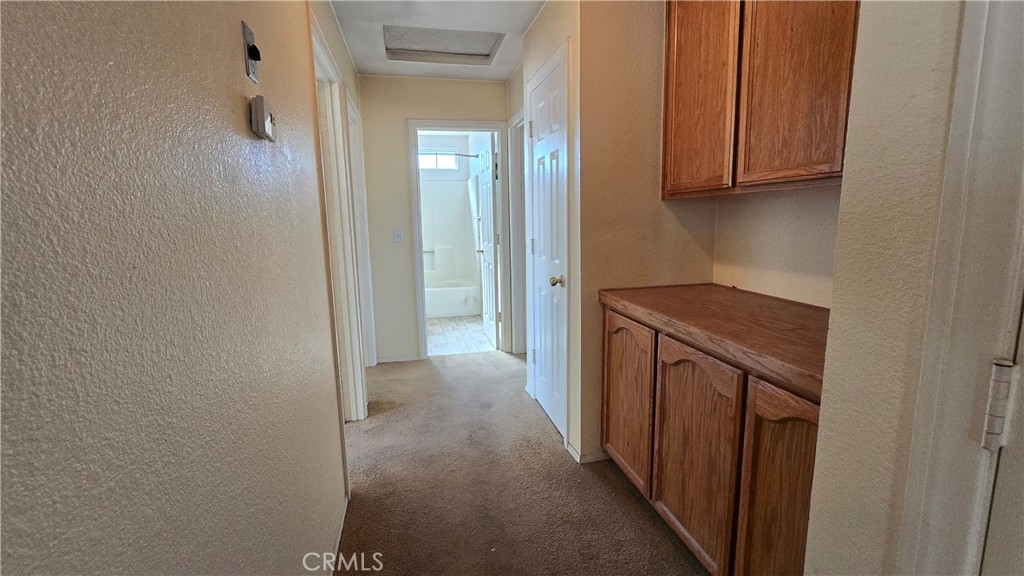 14280 Navajo Road Apple Valley, CA 92307 - Photo 11 of 28 a view of a hallway with washer and dryer