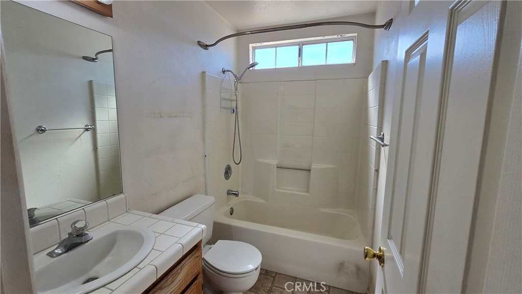 14280 Navajo Road Apple Valley, CA 92307 - Photo 16 of 28 a bathroom with a sink toilet and shower
