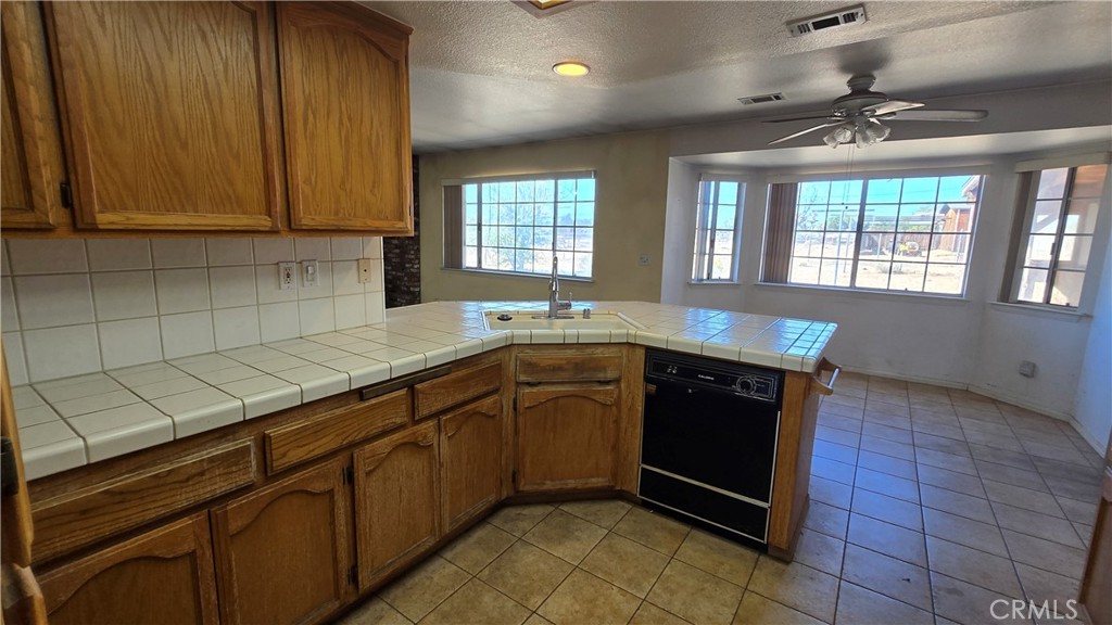 14280 Navajo Road Apple Valley, CA 92307 - Photo 6 of 28 a kitchen with a sink and cabinets