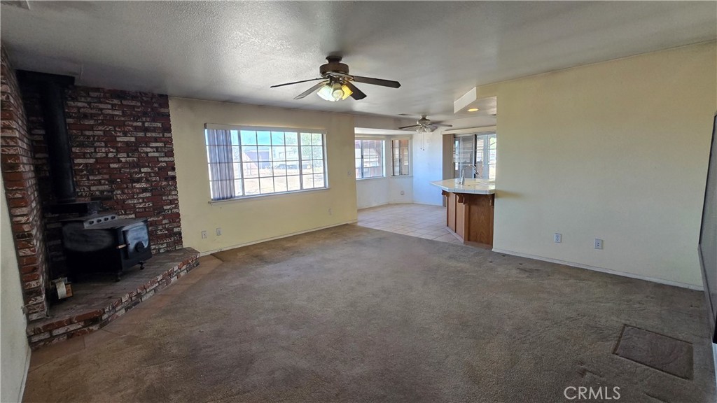 14280 Navajo Road Apple Valley, CA 92307 - Photo 10 of 28 en empty room with windows and ceiling fan