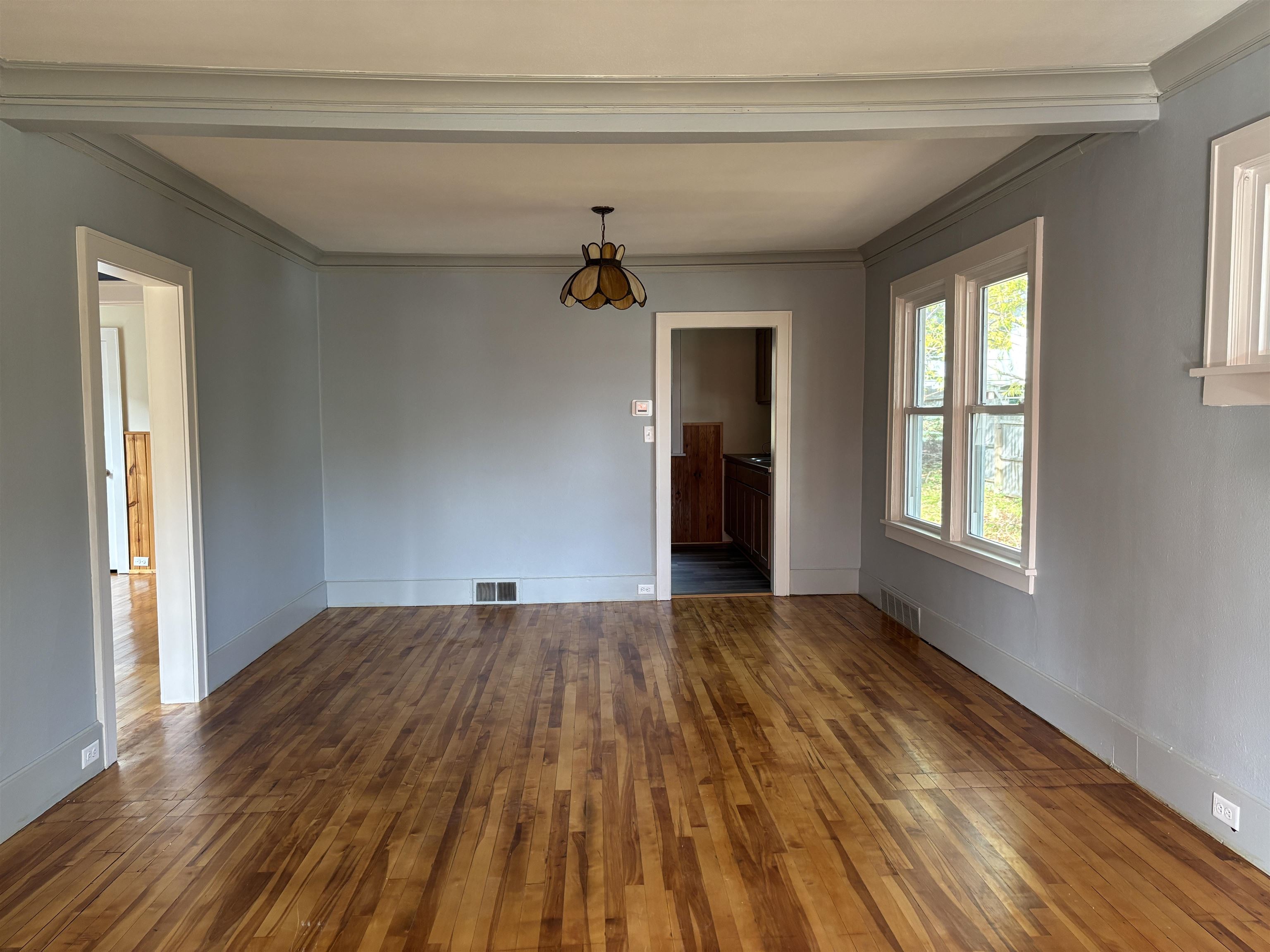 2515 Jefferson Street Duluth, MN 55812 - Photo 11 of 25 Spare room with dark wood-style floors and crown molding