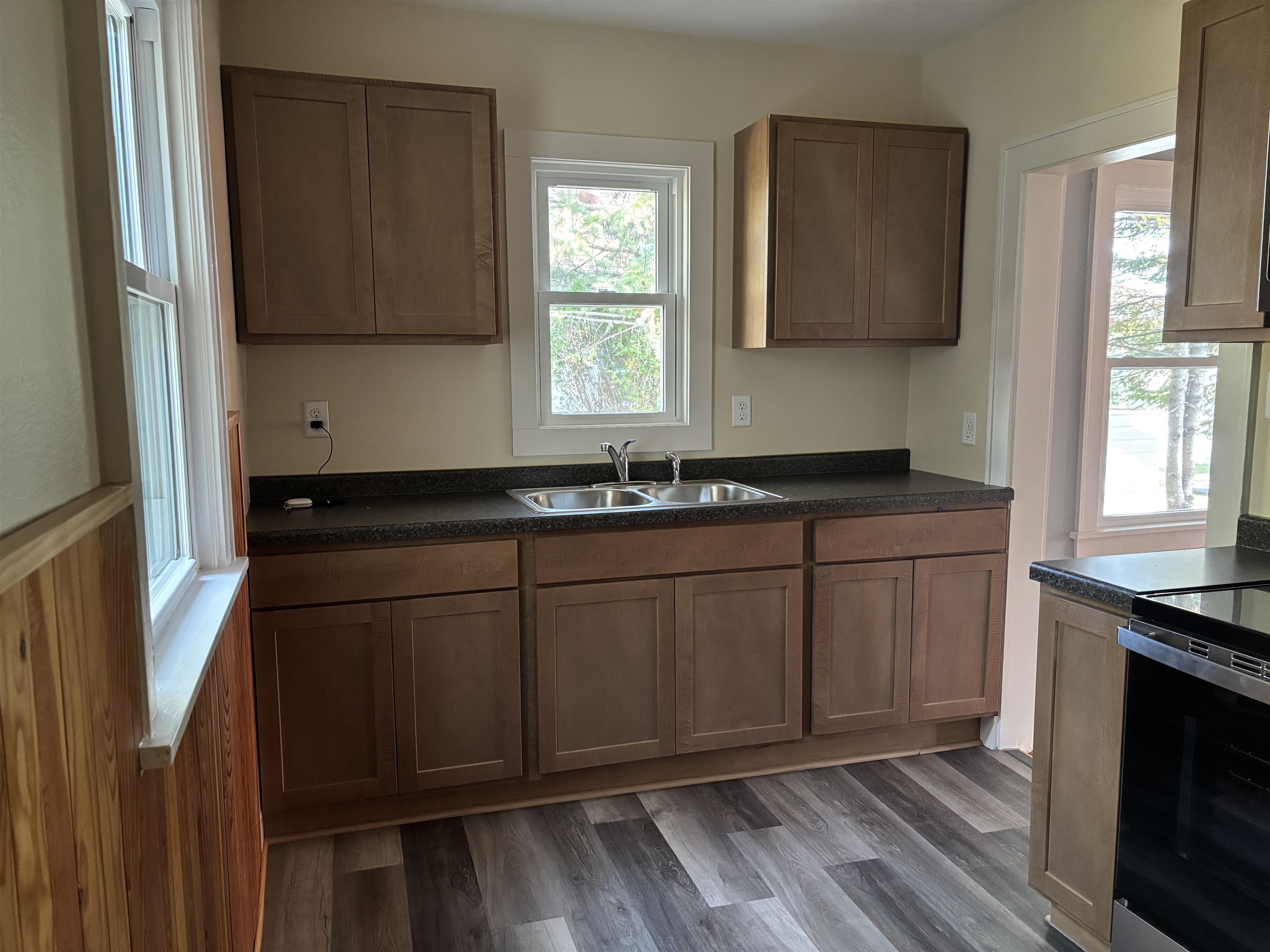 2515 Jefferson Street Duluth, MN 55812 - Photo 12 of 25 Kitchen featuring dark countertops, electric stove, healthy amount of natural light, and dark wood finished floors