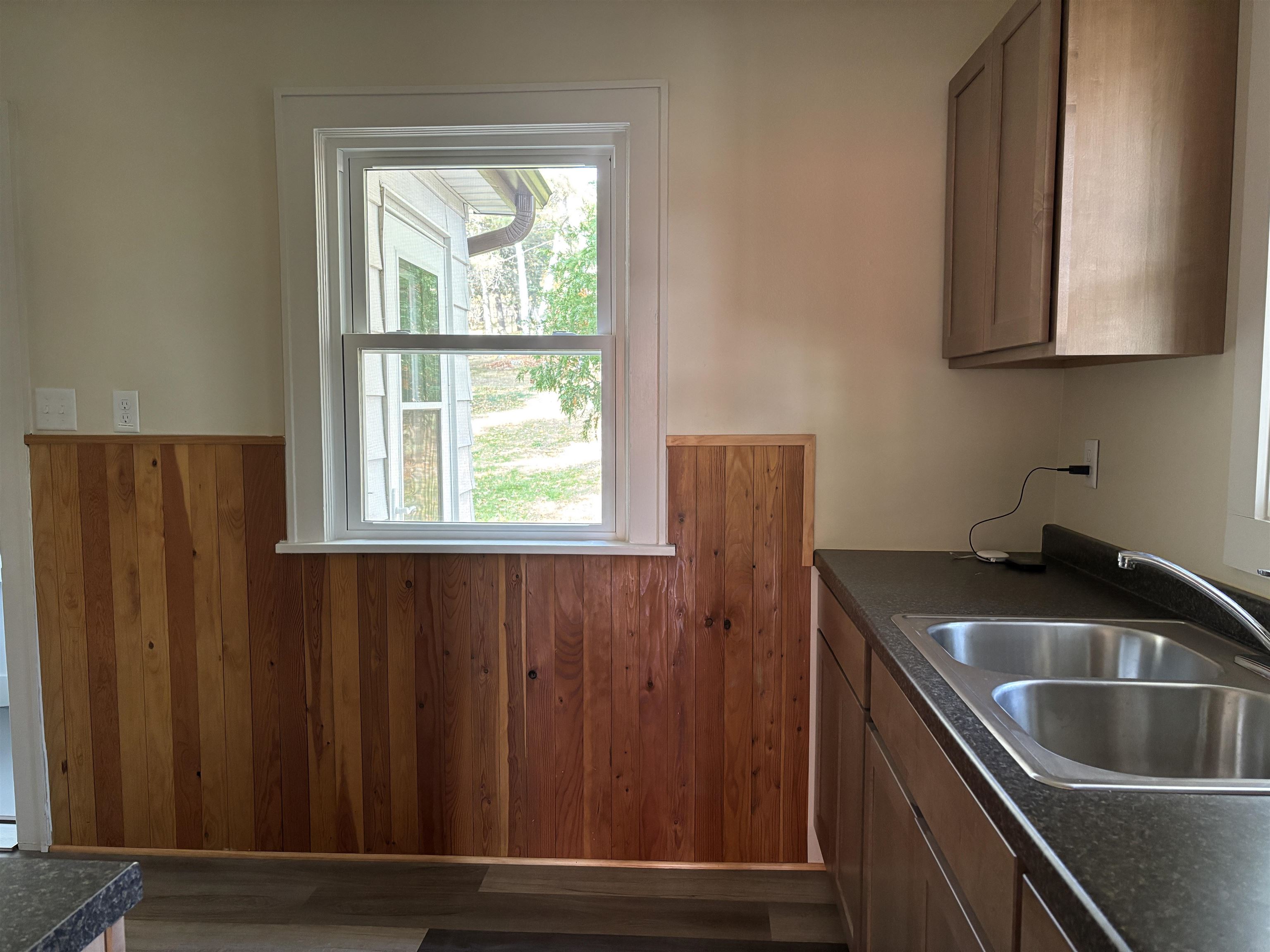 2515 Jefferson Street Duluth, MN 55812 - Photo 15 of 25 Kitchen featuring dark countertops, wood walls, dark wood-style floors, and wainscoting