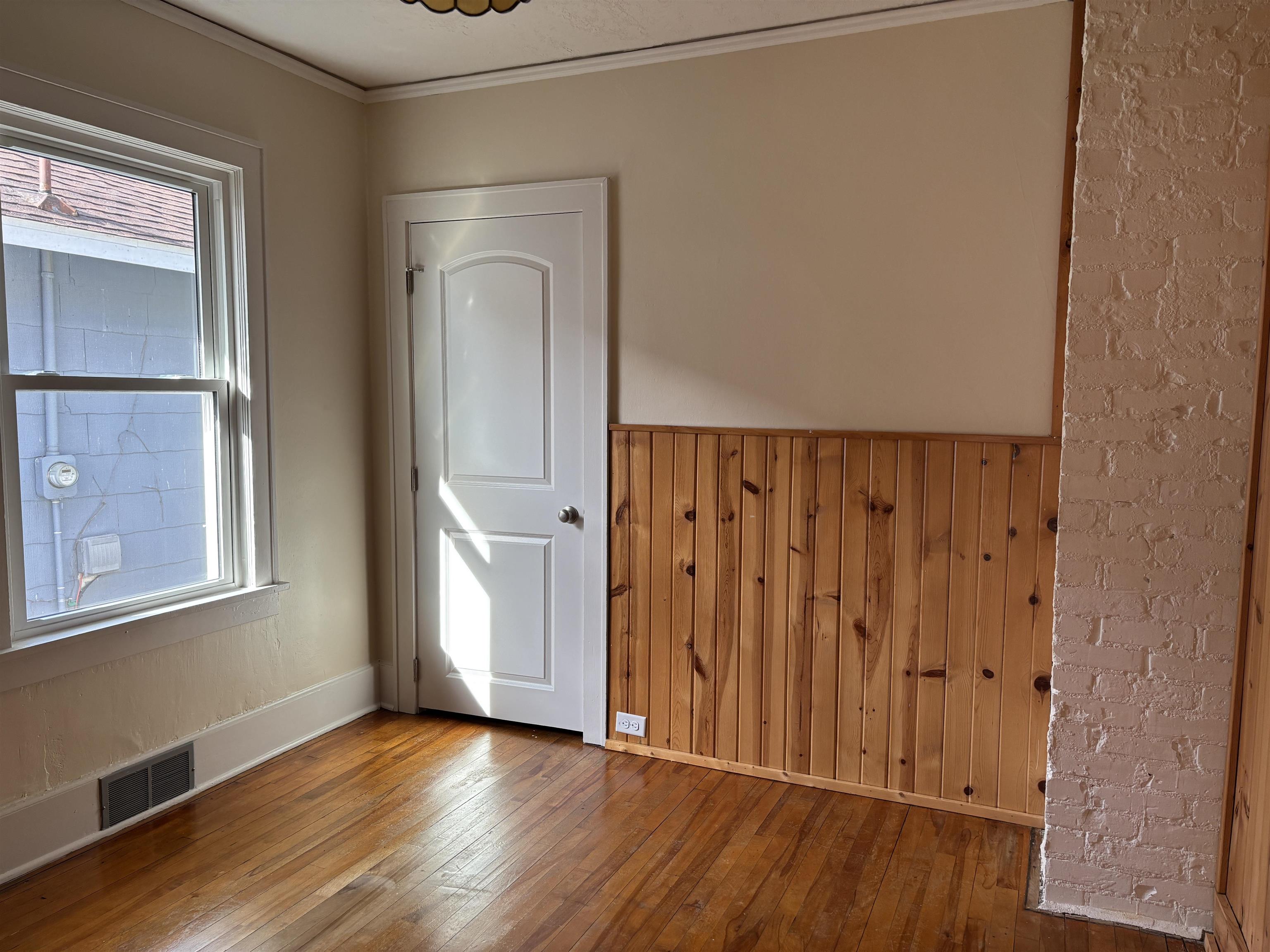 2515 Jefferson Street Duluth, MN 55812 - Photo 16 of 25 Unfurnished room with wood walls, wood-type flooring, and ornamental molding
