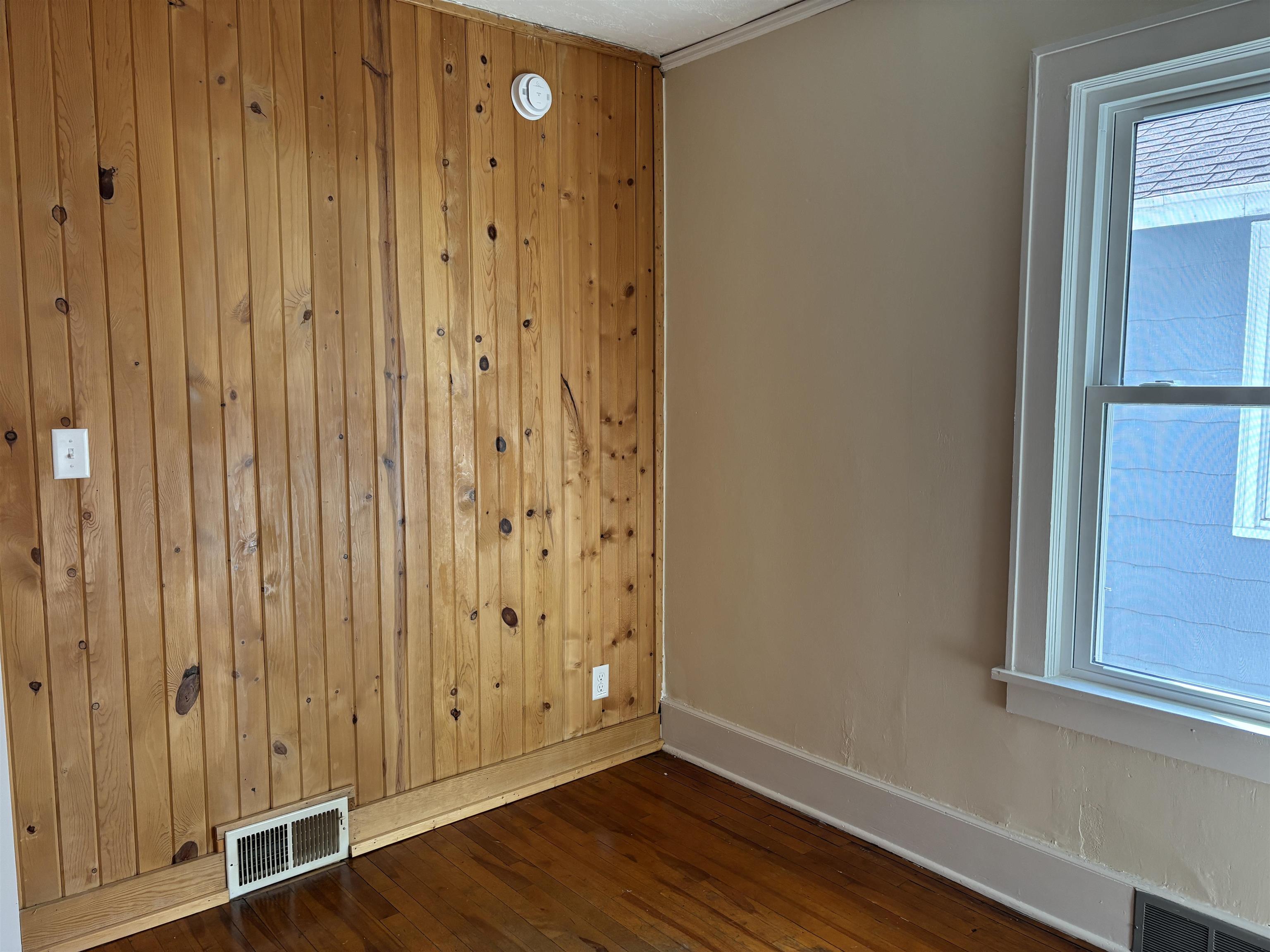 2515 Jefferson Street Duluth, MN 55812 - Photo 17 of 25 Spare room with dark wood finished floors and wood walls
