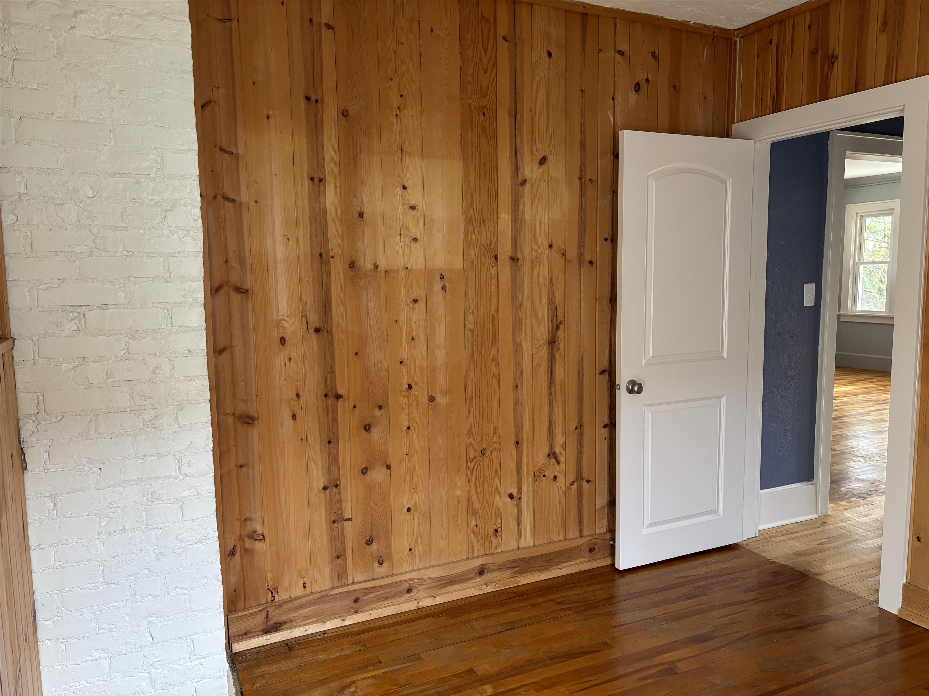 2515 Jefferson Street Duluth, MN 55812 - Photo 18 of 25 Spare room featuring hardwood / wood-style flooring and wood walls