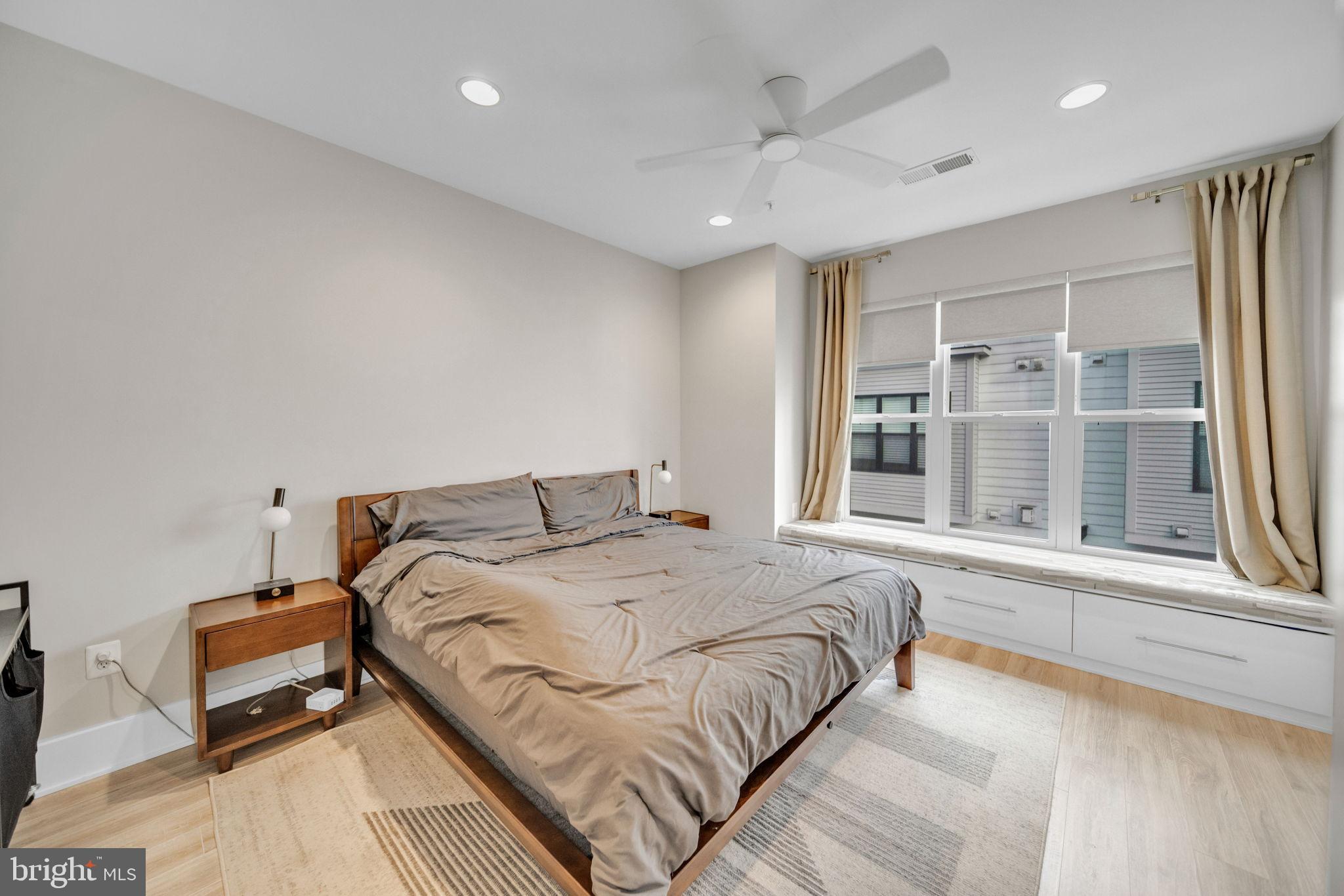 11326 Emerald Park Road Potomac, MD 20854 - Photo 12 of 40 a large bedroom with a bed and wooden floor