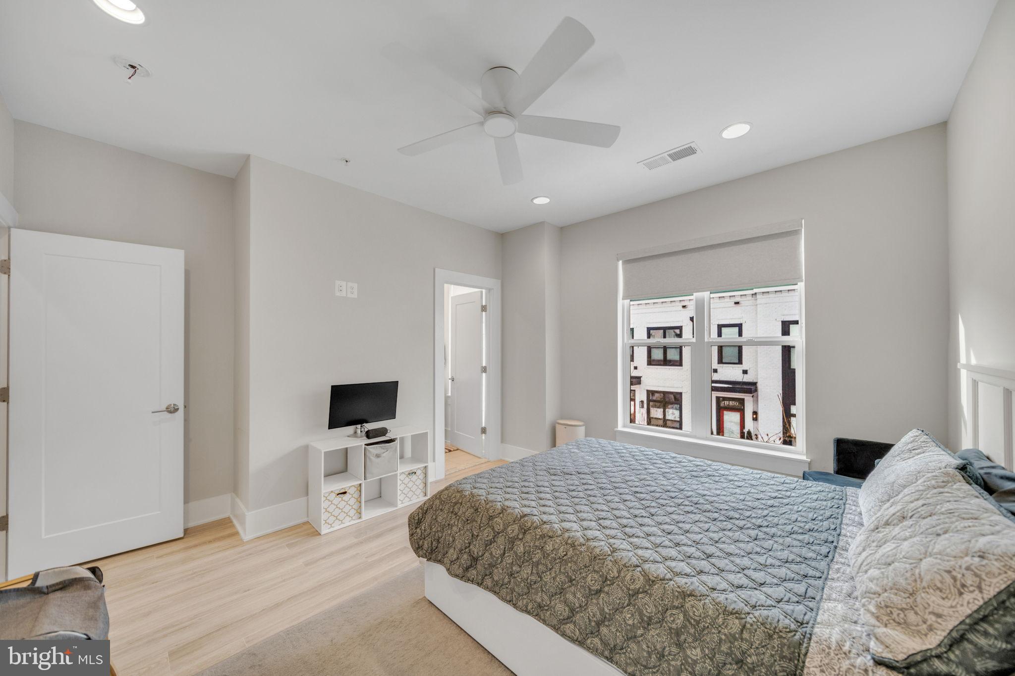 11326 Emerald Park Road Potomac, MD 20854 - Photo 16 of 40 a bedroom with a large bed and a flat screen tv