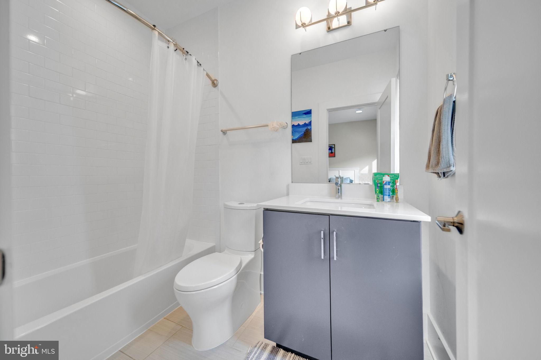 11326 Emerald Park Road Potomac, MD 20854 - Photo 17 of 40 a bathroom with a sink a toilet and shower