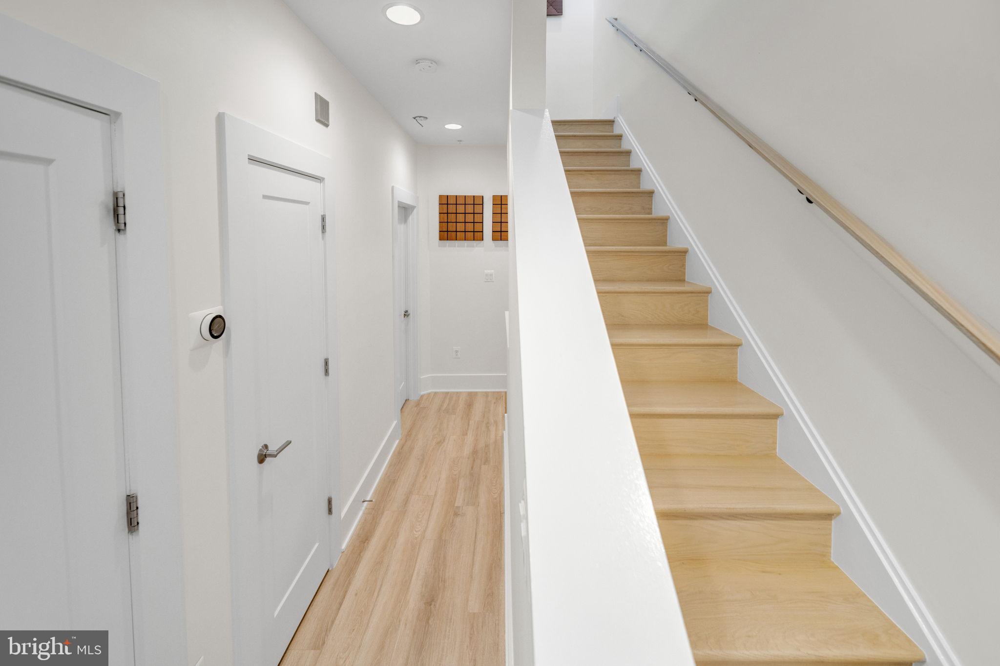 11326 Emerald Park Road Potomac, MD 20854 - Photo 19 of 40 a view of staircase with white walls and railing